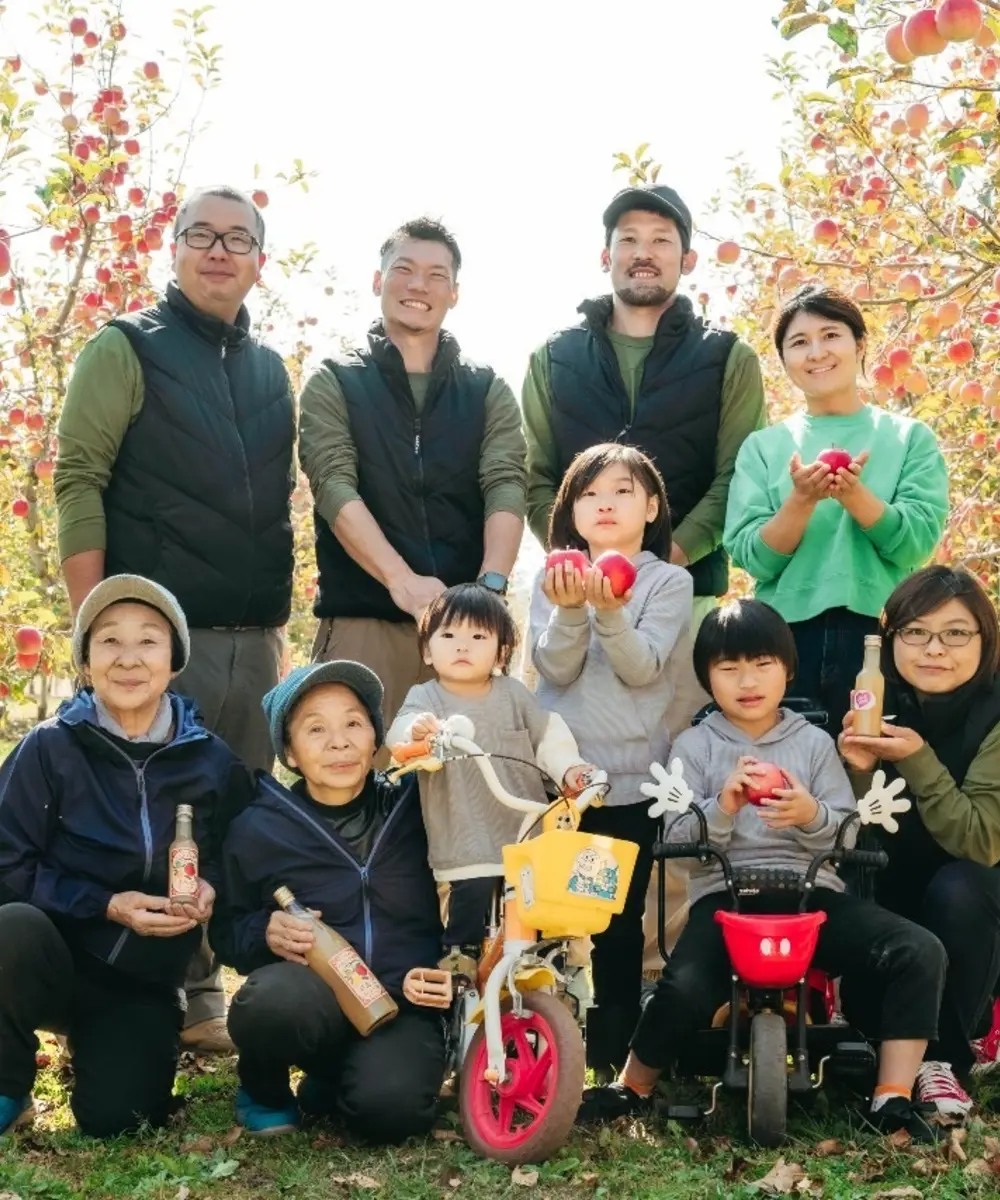 People gathered in an Azumino apple orchard