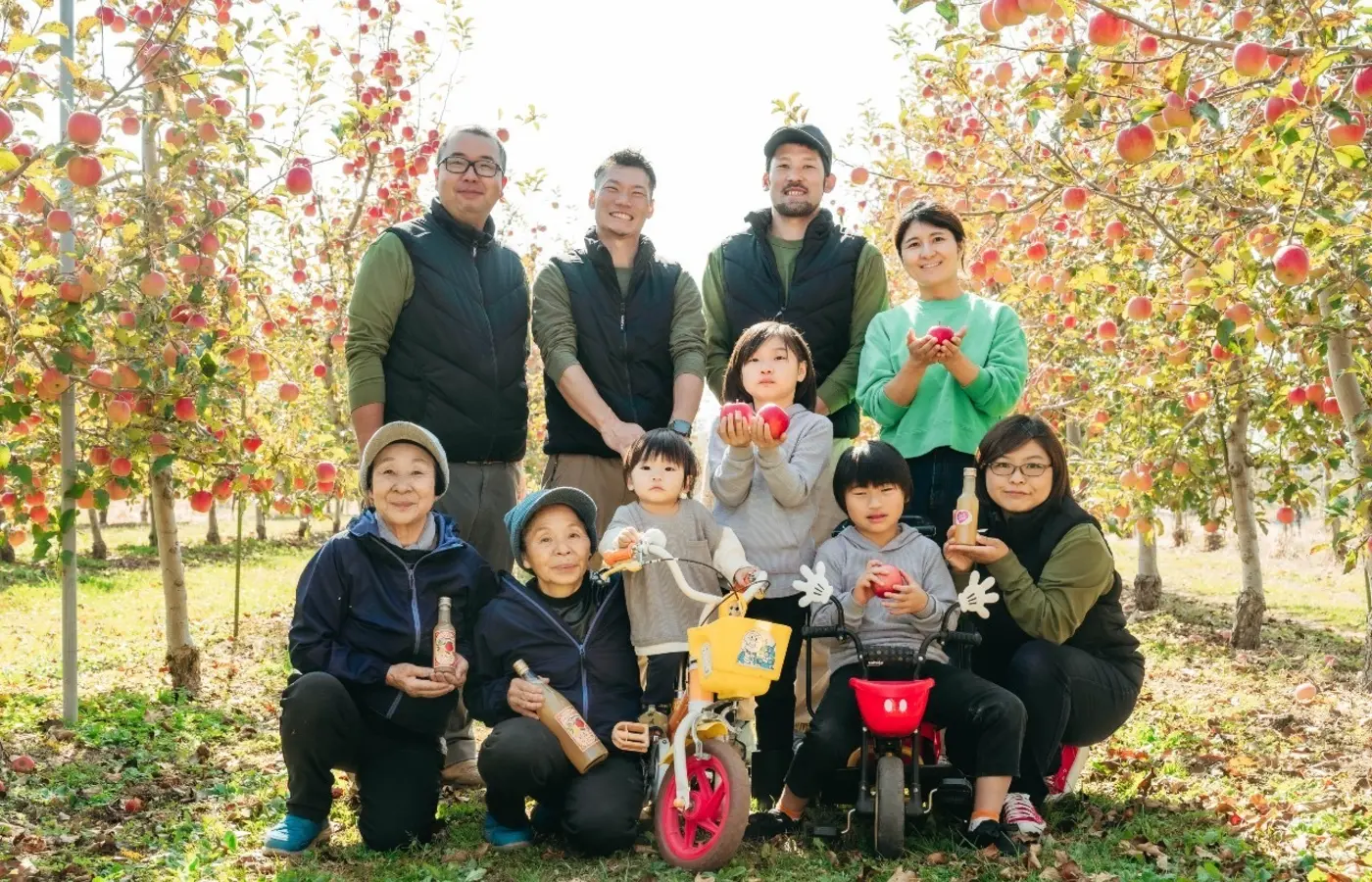Visitors and local hosts gathering in an apple orchard